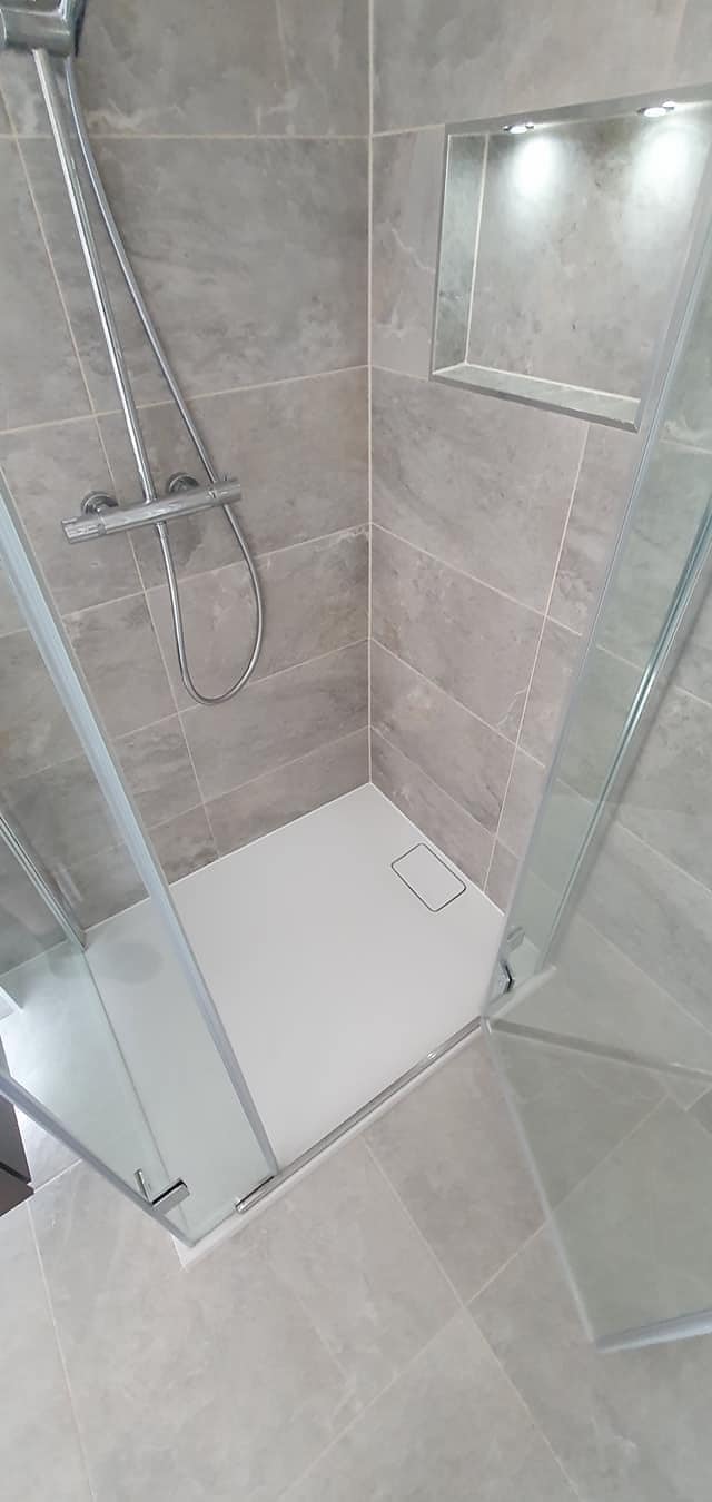 Walk-in shower with recessed alcove niche light installed by Matrix FSE, clean finish in tiled wet room