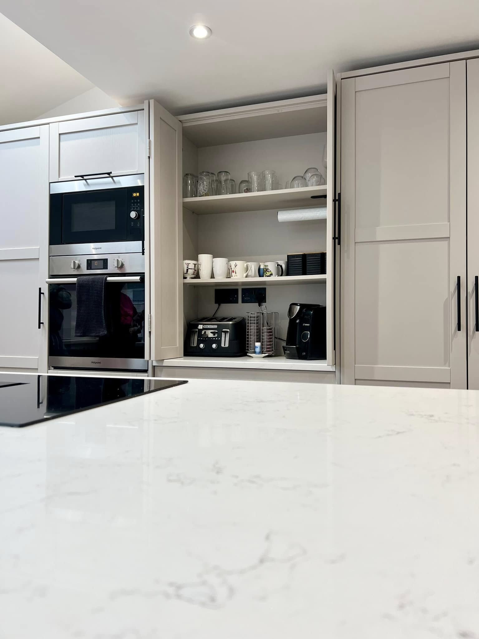Kitchen larder and oven with LED downlight above