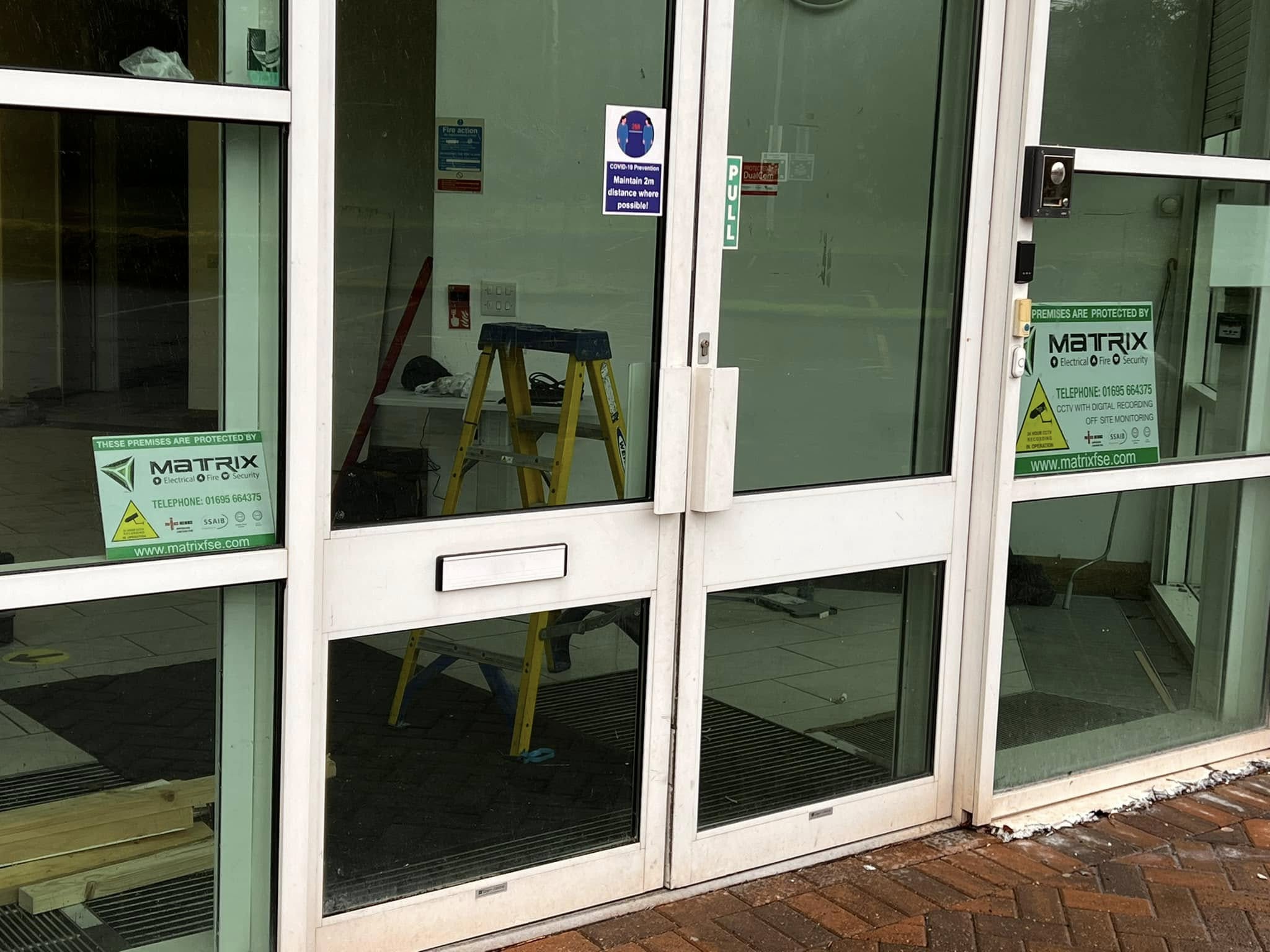 Fire and security system components installed on office wall