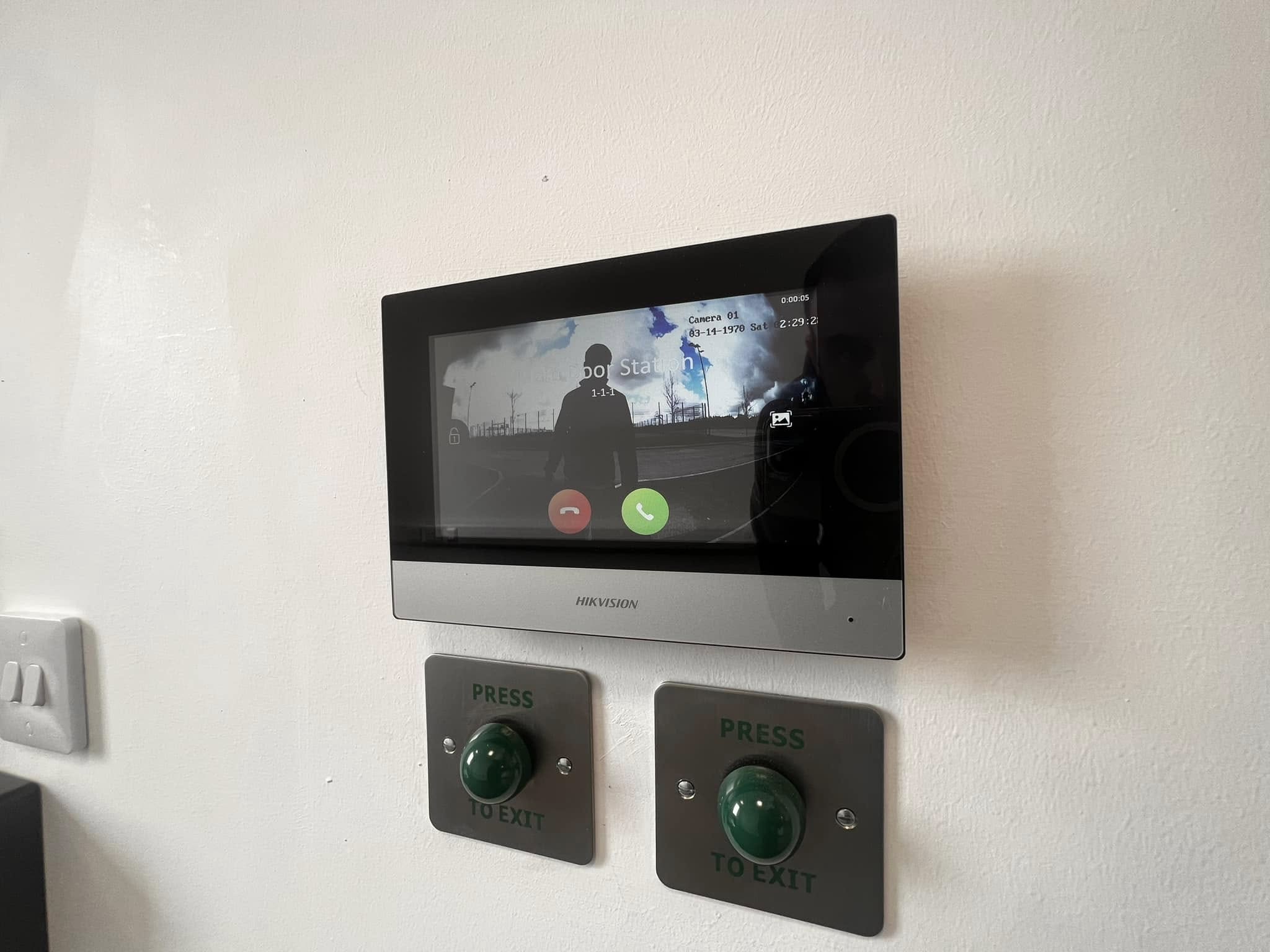 Hikvision video door entry panel with press-to-exit buttons installed by Matrix FSE
