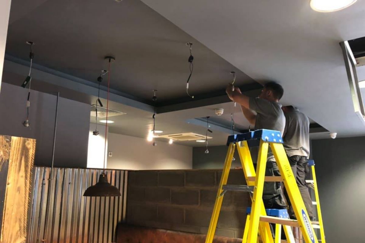 Matrix FSE team installing commercial LED pendant lighting